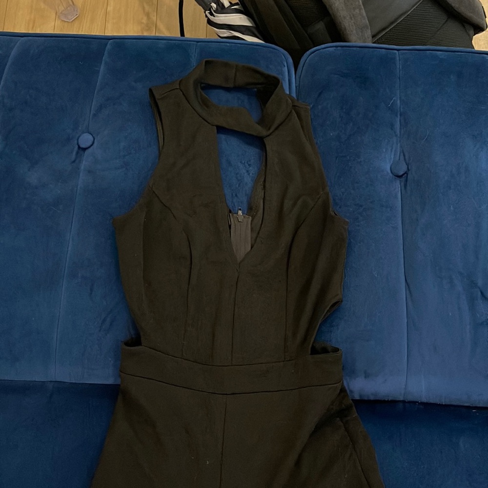 Black jumpsuit with zip back and buttons behind neck